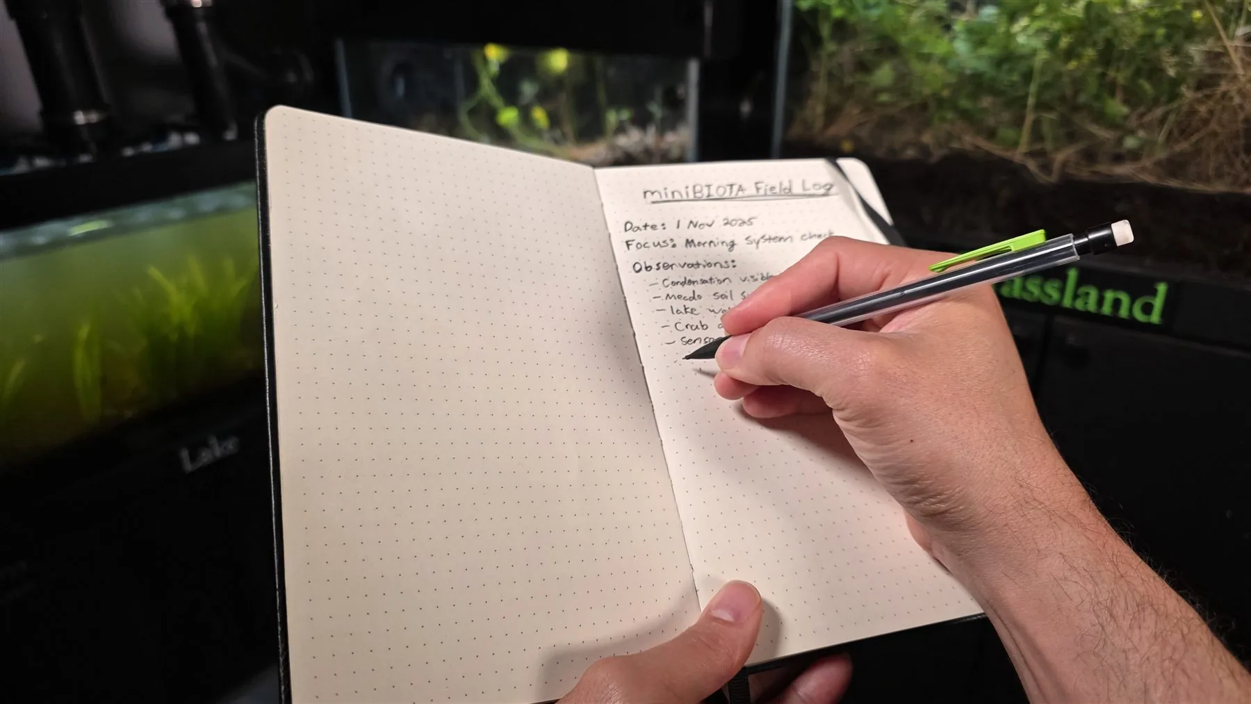 A field notebook beside the miniBIOTA enclosure.