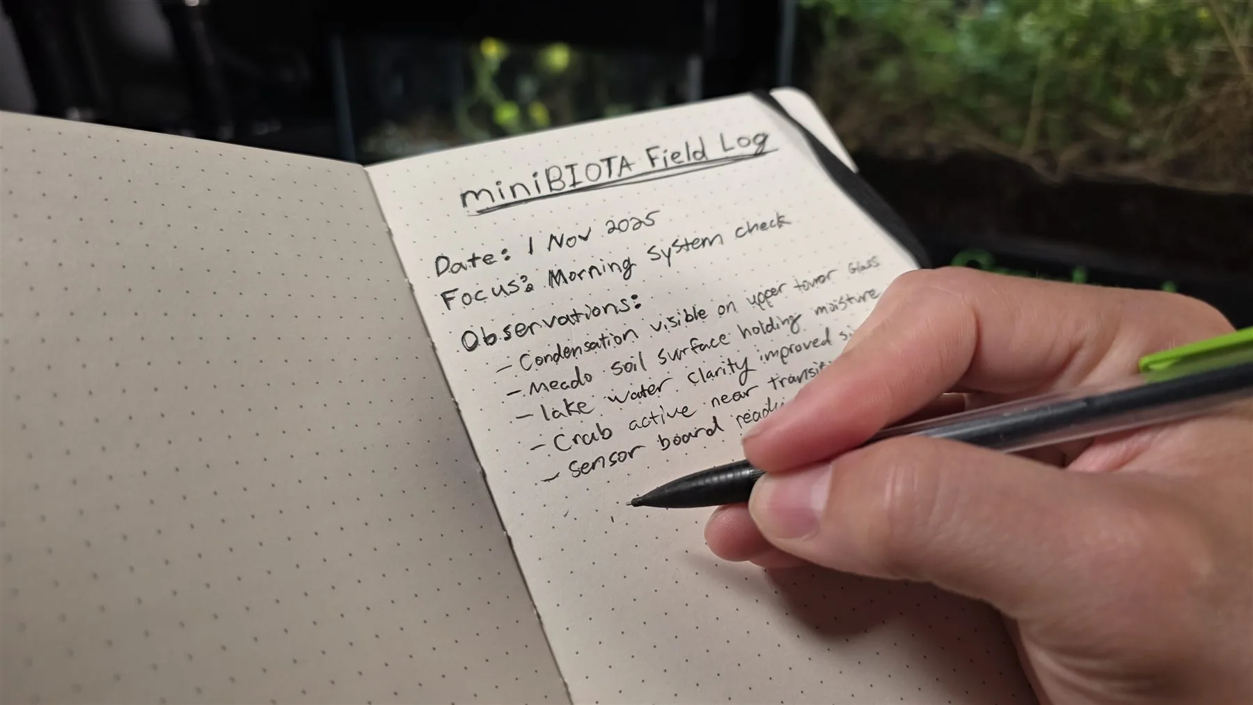 Handwritten miniBIOTA field log with observations beside the living biosphere